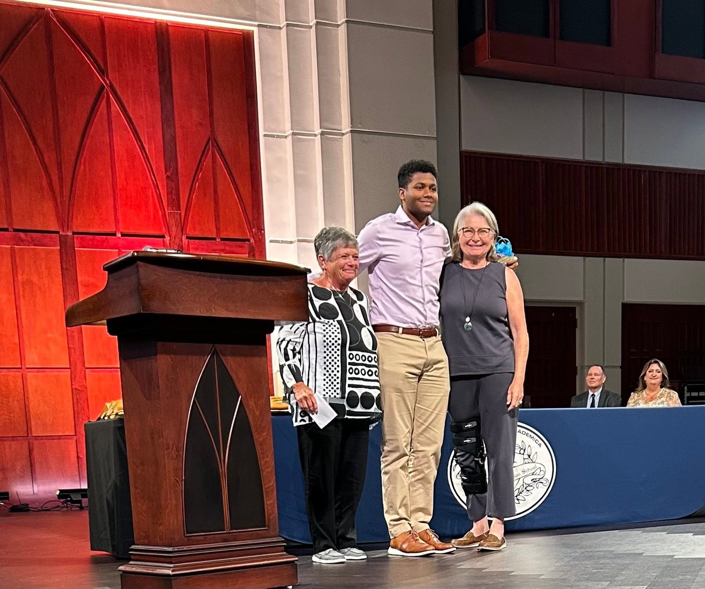 Valerie Players president Sue Whitney and treasurer Linda Bega present Nathan Browne with a $1,500 scholarship at Seven Rivers Christian School